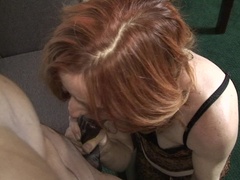 Red mature slut munching on a big black cock
