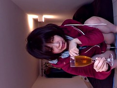 Peeing asian fills glass