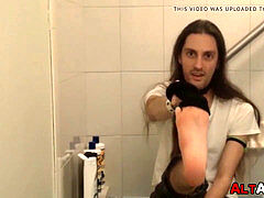 long haired dude working on his boner on the bathtub