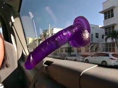 Long hair babe fucking a dildo in a van